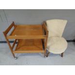 A mid 20th century teak two-tier tea trolley together with a bedroom chair upholstered in a floral