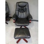 A stained beech framed armchair upholstered in black leather together with matching stool.