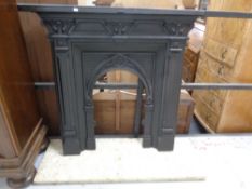 A 19th century cast iron fire insert with hearth.