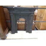 A 19th century cast iron fire insert with hearth.