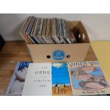 A crate containing a quantity of vinyl LPs and 12" singles to include Madonna, Elton John,