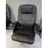 An electric massage armchair upholstered in black leather.