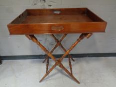 A beech butler's tray on X-frame stand