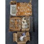 Two boxes containing a large quantity of assorted glassware to include amber glass decanters and