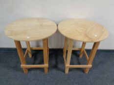 A pair of contemporary pine circular occasional tables