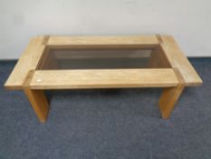 A contemporary oak rectangular coffee table with glass inset panel