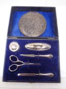 A cased silver manicure set and a compact stamped 800.