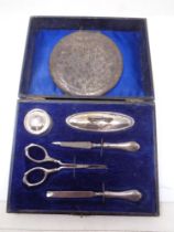 A cased silver manicure set and a compact stamped 800.