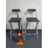 A Von Haus electric vacuum together with two folding breakfast bar stools