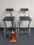 A Von Haus electric vacuum together with two folding breakfast bar stools