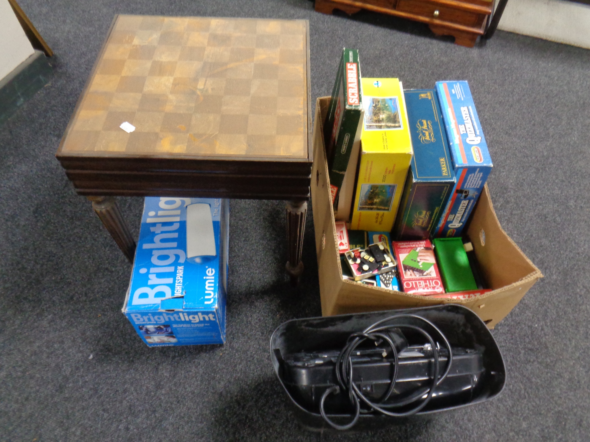 A box containing assorted board games, jigsaw, domino's, card games, together with a paper shredder,