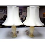 A pair of cream marble table lamps with shades