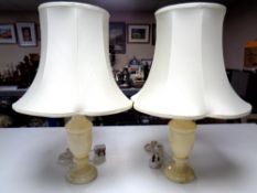 A pair of cream marble table lamps with shades