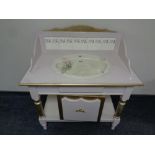 A painted and gilt washstand with ceramic sink