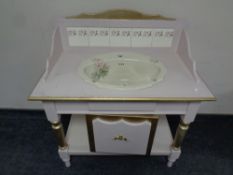 A painted and gilt washstand with ceramic sink