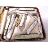 A small collection of assorted pocket knives to include a silver mother of pearl handled fruit