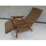 A mid 20th century teak framed reclining armchair with foot rest.