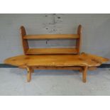 A rustic plank top bench on pine X-framed base together with a teak wall shelf.