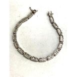 An 18ct white gold diamond set bracelet with 20 panels of baguette and round cut diamonds,