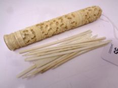 A heavily carved bone needle case