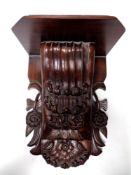 A 19th century style carved wooden wall bracket