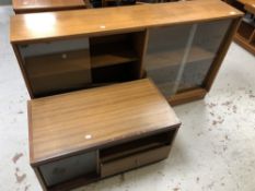 A set of mid 20th century teak sliding glass door book shelves together with a teak effect audio