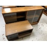 A set of mid 20th century teak sliding glass door book shelves together with a teak effect audio