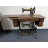 A Singer treadle sewing machine in oak table