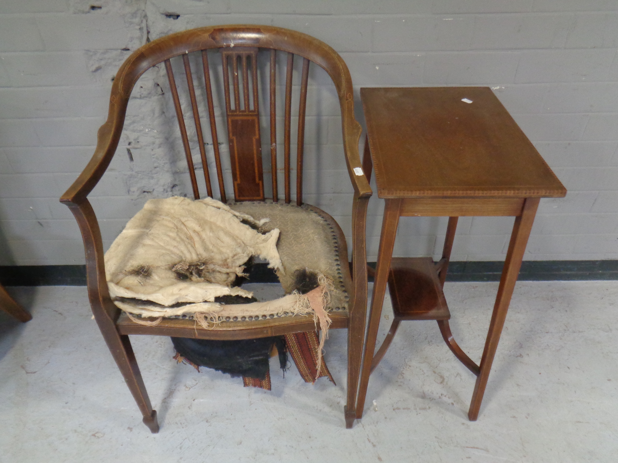 An Edwardian inlaid mahogany two tier occasional table together with a mahogany armchair