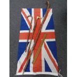 A Union flag together with 3 walking sticks and an extending wooden ruler