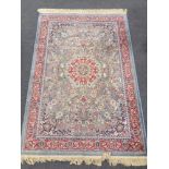 A machine made rug of Isfahan design on blue ground 181 cm x 117 cm