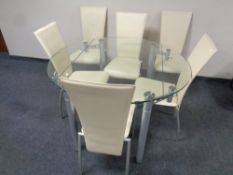A contemporary glass and metal flap sided circular dining table together with a set of 6 chairs