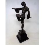An after Chiparus bronze sculpture of an Art Deco dancer on a black marble base.