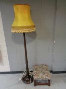 A beech standard lamp with shade together with a tapestry upholstered foot stool.