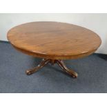 A Victorian rosewood circular dining table.