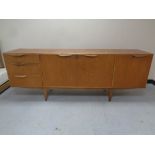 A mid 20th century teak Mcintosh furniture triple door cocktail sideboard fitted three drawers on