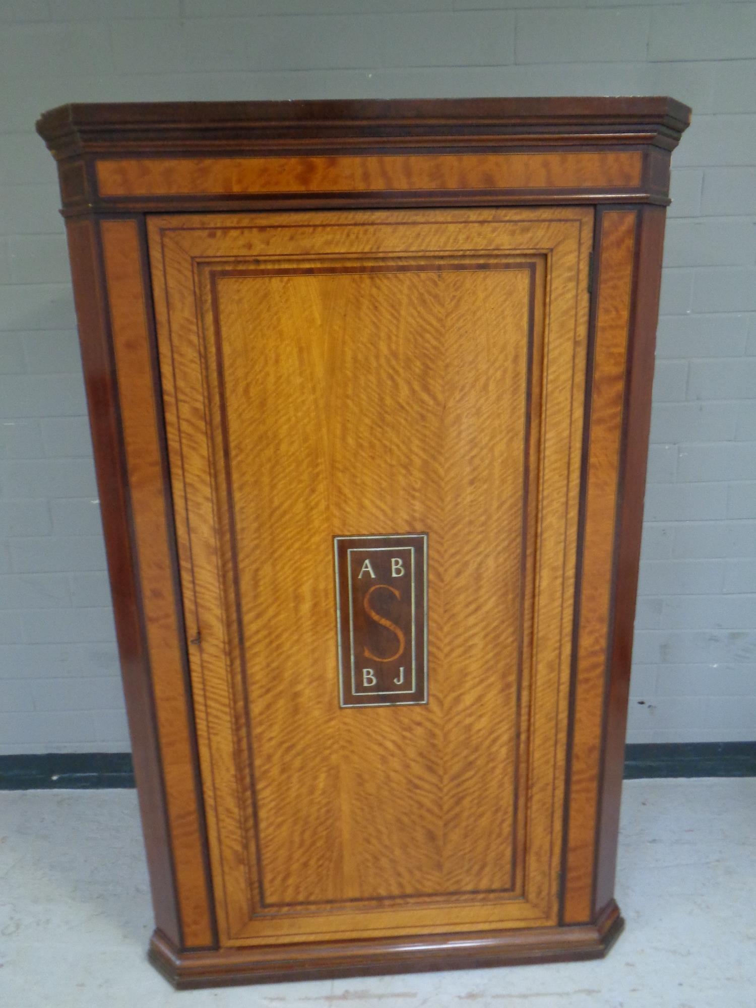 A 19th century inlaid mahogany corner cabinet