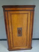 A 19th century inlaid mahogany corner cabinet