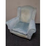 A Victorian style wingback armchair in blue upholstery