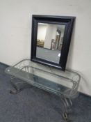 A contemporary glass and wrought metal coffee table together with a black framed mirror