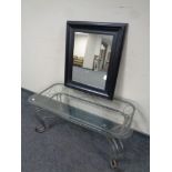 A contemporary glass and wrought metal coffee table together with a black framed mirror