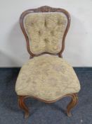 A late Victorian salon chair in buttoned upholstery