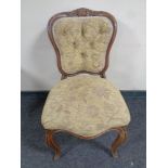 A late Victorian salon chair in buttoned upholstery