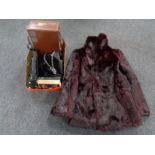 A faux fur coat together with a box containing assorted leather handbags,