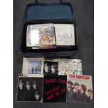 A suitcase containing vinyl LPs to include Pink Floyd, The Beatles, Rolling Stones,