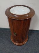 A circular mahogany pot cupboard with marble inset top