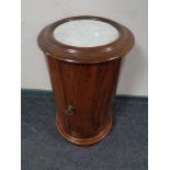 A circular mahogany pot cupboard with marble inset top