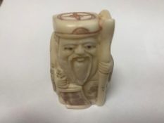 A Japanese bone carving - Village Elder with Scroll.