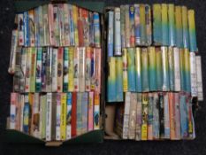 Two boxes containing ninety-five Biggles volumes by W E Johns