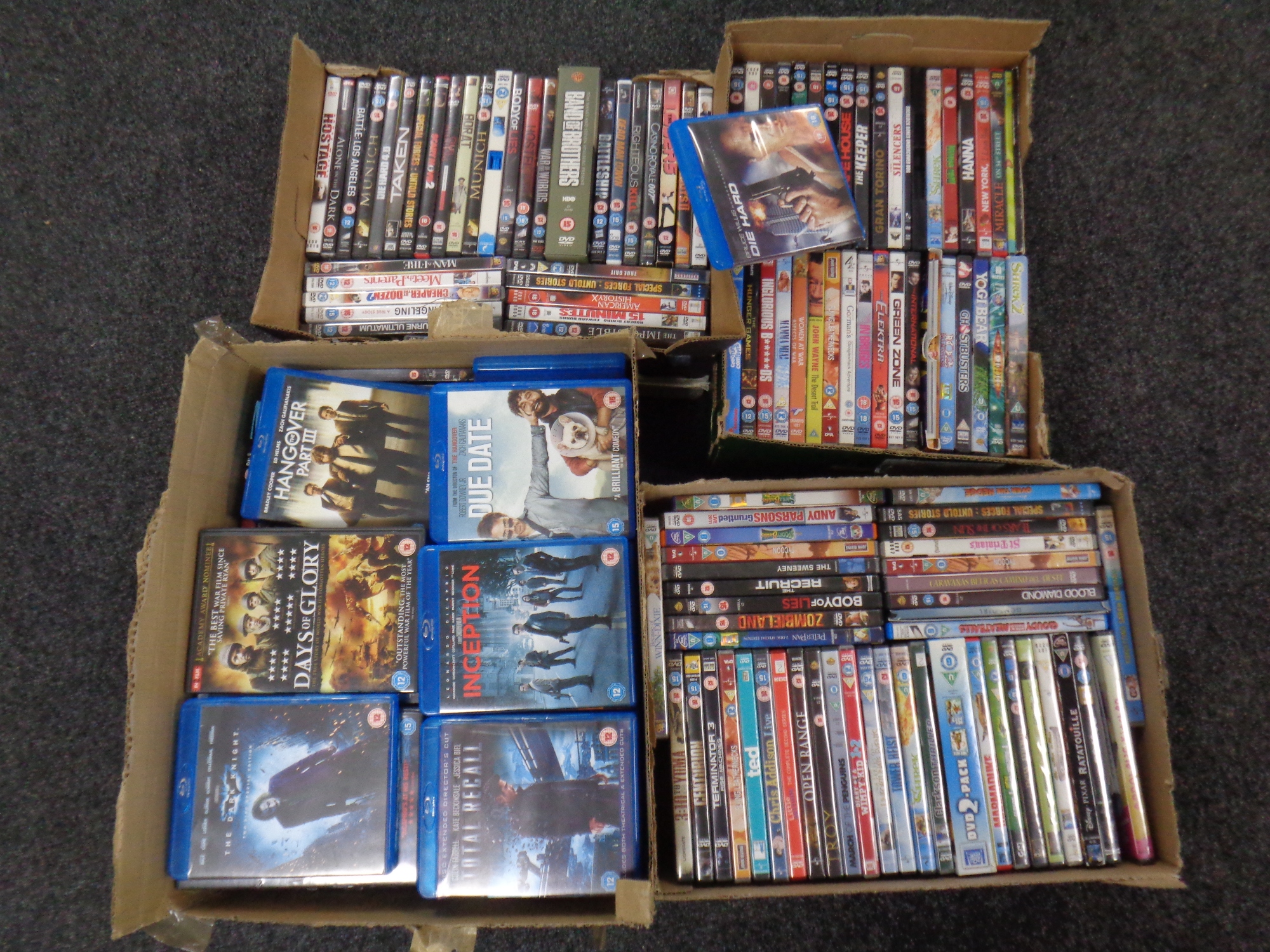 Four boxes containing assorted DVDs and Blu Rays